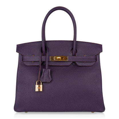Deep Raisin Purple Medium Structured Top Handle Tote With Full Pebbled Grain Surface, Polished Golden Twist Hardware And Matching Lock Tassel Pendant Set