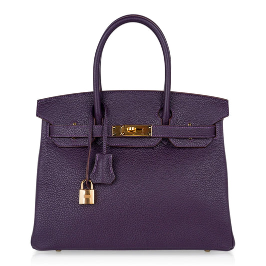 Deep Raisin Purple Medium Structured Top Handle Tote With Full Pebbled Grain Surface, Polished Golden Twist Hardware And Matching Lock Tassel Pendant Set
